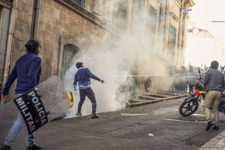 Demonstrators face members of Bolivia's military as Bolivia's President Luis Arce 