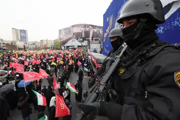 Security personnel stand guard as Iranians take part in a protest marking the annual al-Quds Day (Jerusalem Day) on the last Friday of the holy month of Ramadan in Tehran, Iran, March 13, 2026. REUTERS/Alaa Al Marjani